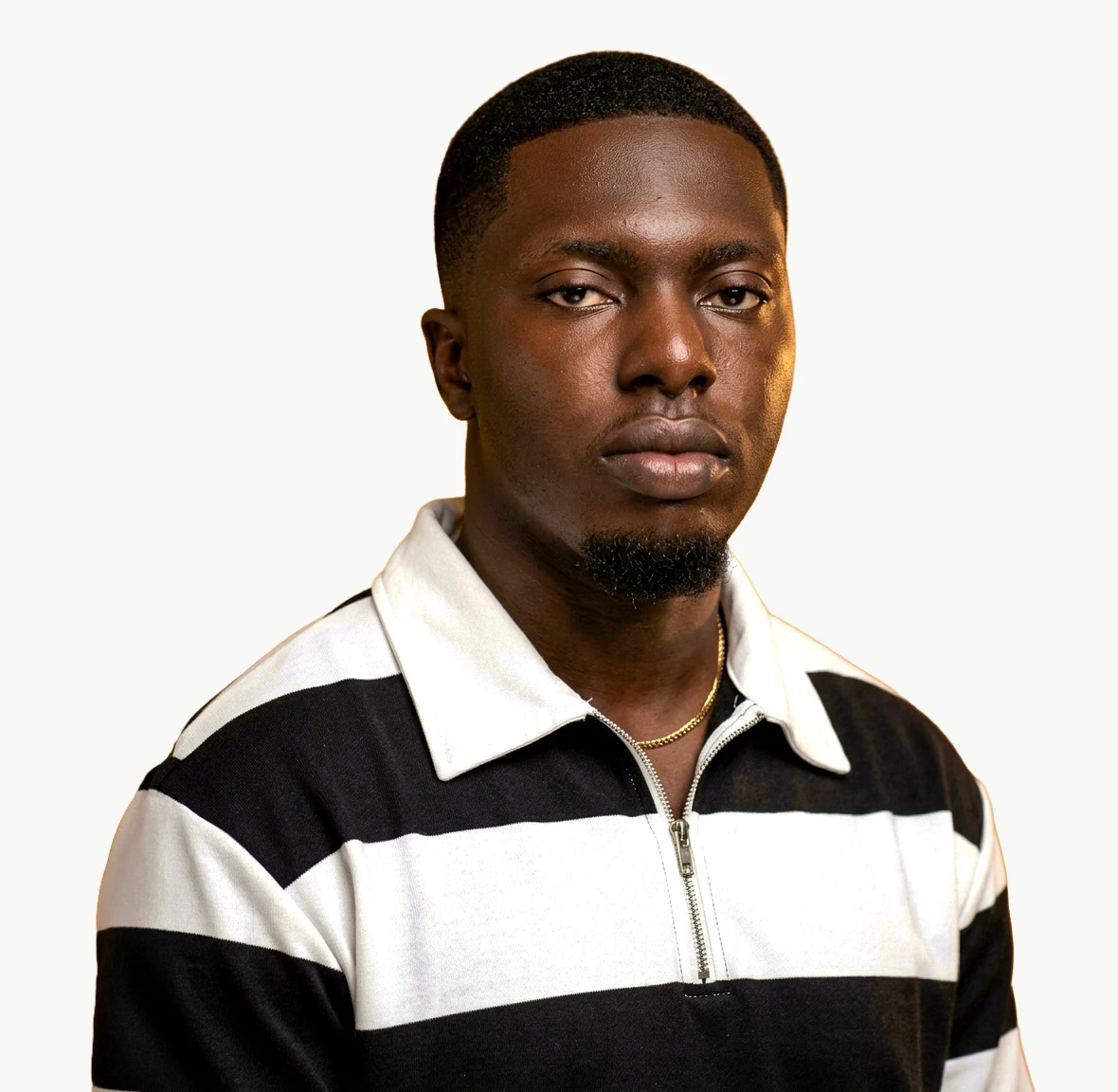 Portrait of Papa Kwesi Buadoo, a Ghanaian designer and art director, against a warm off-white background.